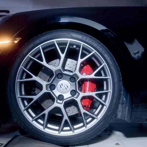Closeup of a Porsche tire and rim on dyno tuner